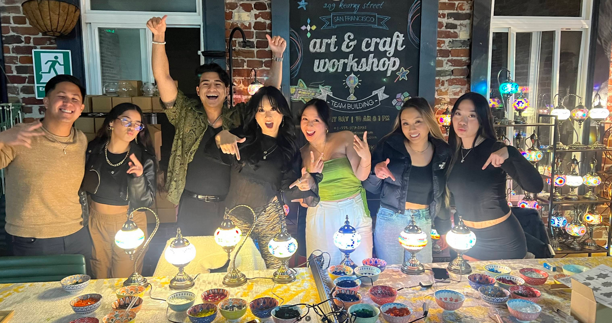 A group of friends celebrates a birthday party together at a KraftStories NYC workshop.