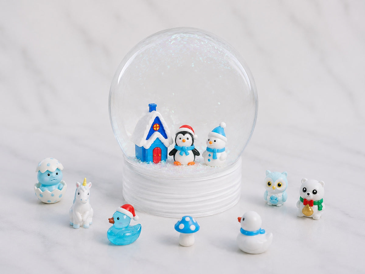 Snow globe photographed at an angle with its painted figures beside it