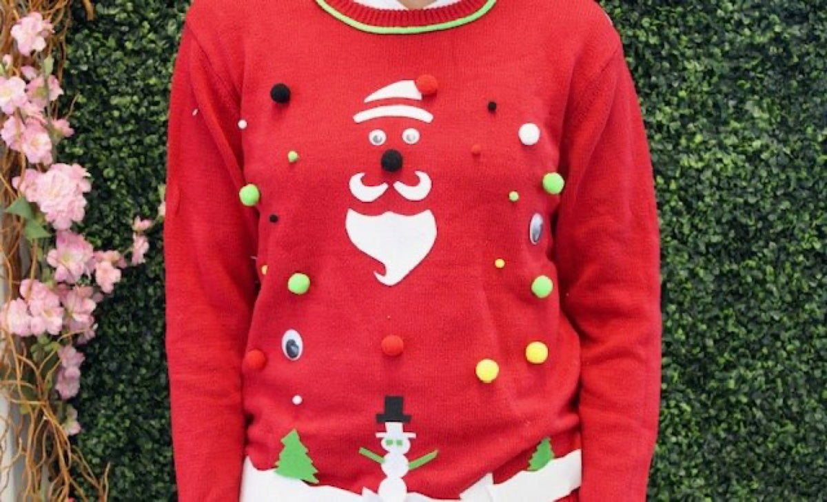 Finished red ugly Christmas sweater with a felt face, pompoms and trees