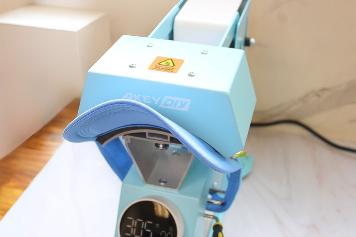 Heat press machine closing on a green trucker hat