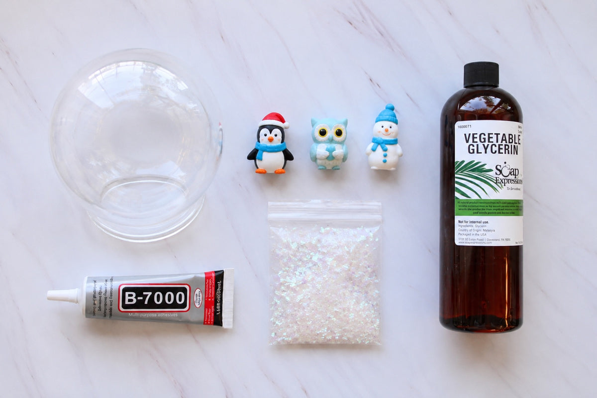 Snow globe kit: clear globe, base, painted figures, glitter and a bottle of glycerin