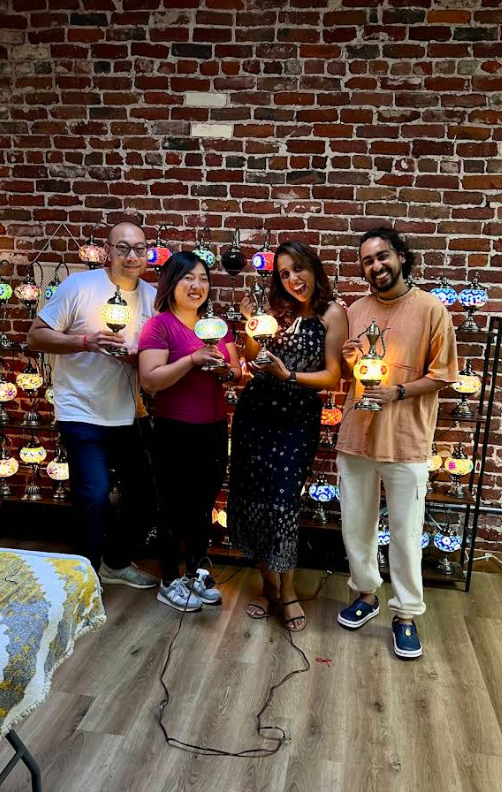 Four friends holding glowing lamps