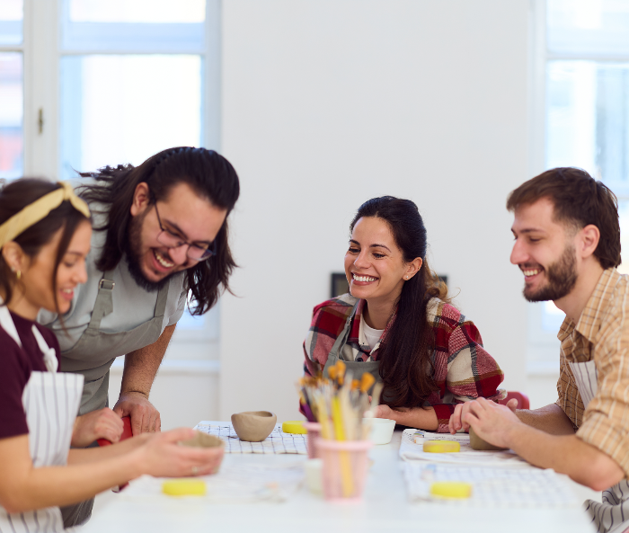 Group smiling at pottery class