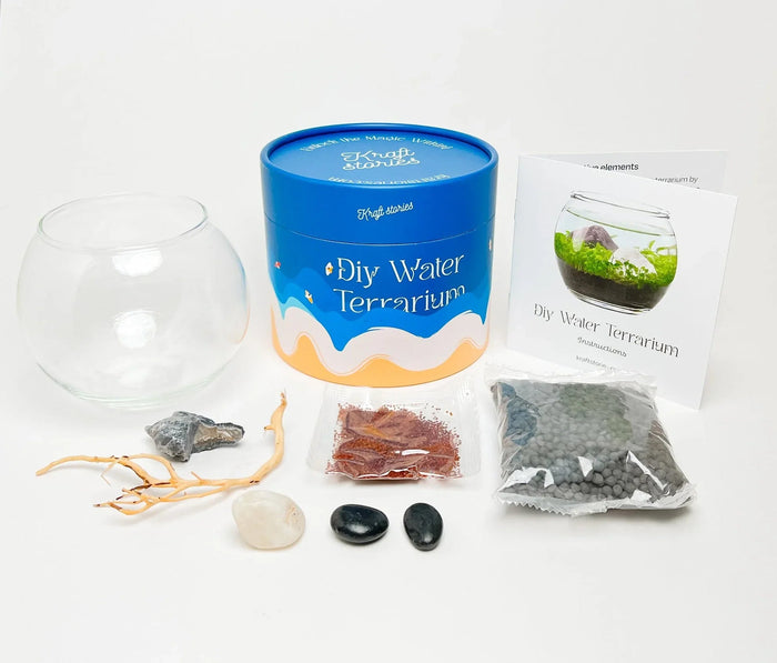 DIY Water Terrarium kit with glass dome, blue packaging, soil, stones, and instruction manual.
