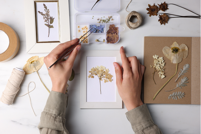 Creating delicate botanical art during a professional pressed flower workshop.