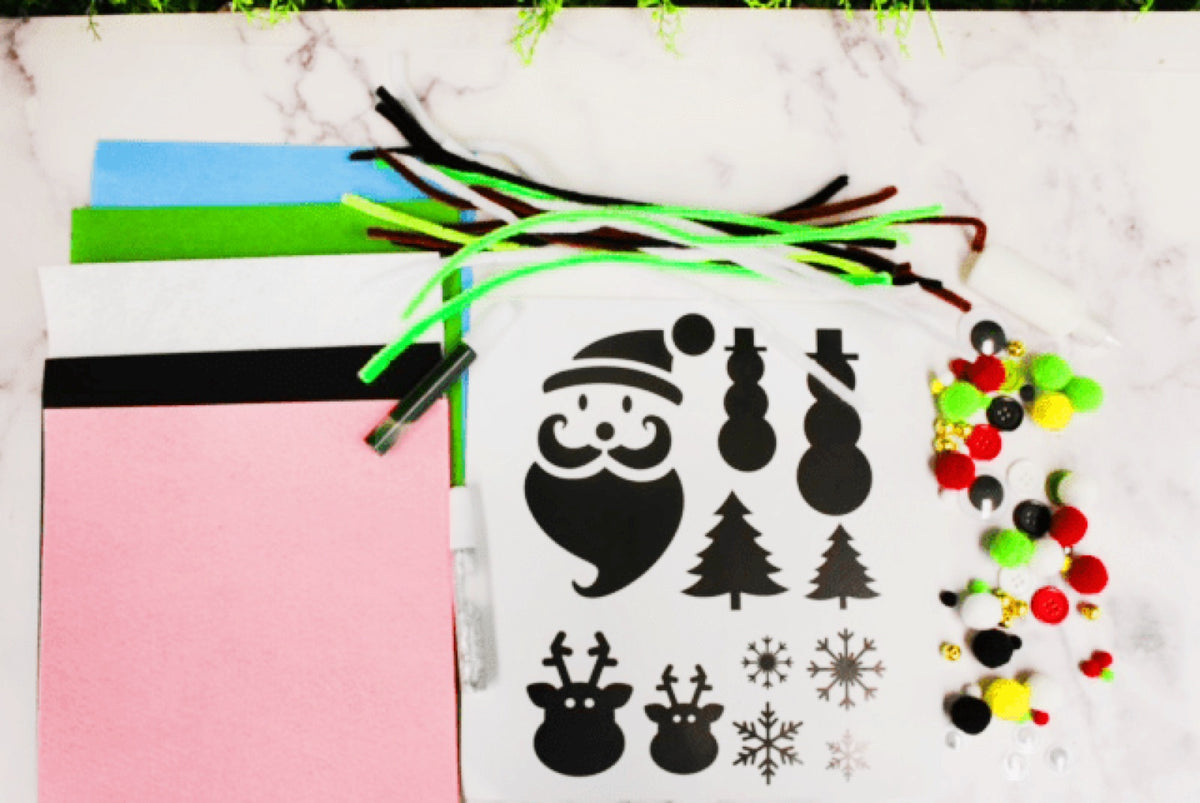 Felt stencils, pompoms and trim laid out ready to decorate a sweater