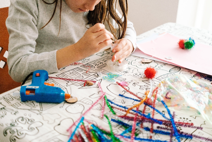 Child crafting with pipe cleaners