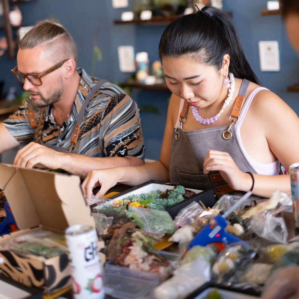 Couple doing moss wall art workshop