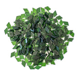 Assorted dark green glass mosaic tiles in a variety of diamond shapes.