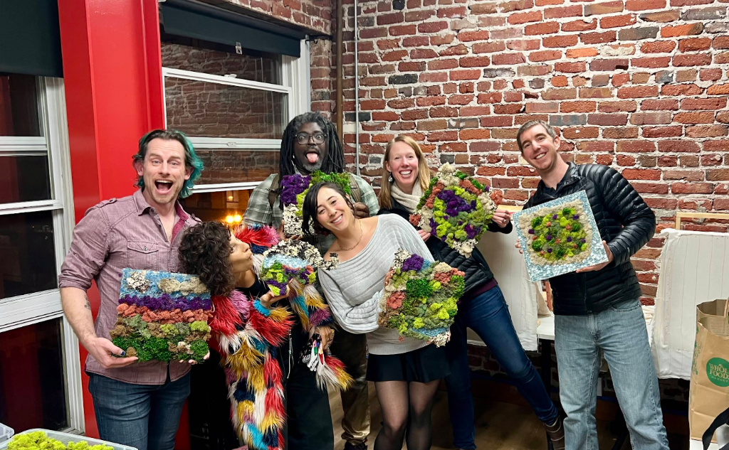 Group holding finished moss art