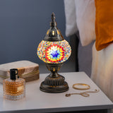 A colorful, ornate Turkish mosaic lamp with intricate patterns and designs, creating a warm and elegant ambiance in the room.