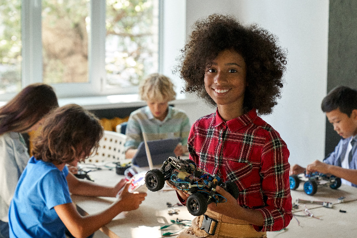 Student holding finished robotic car