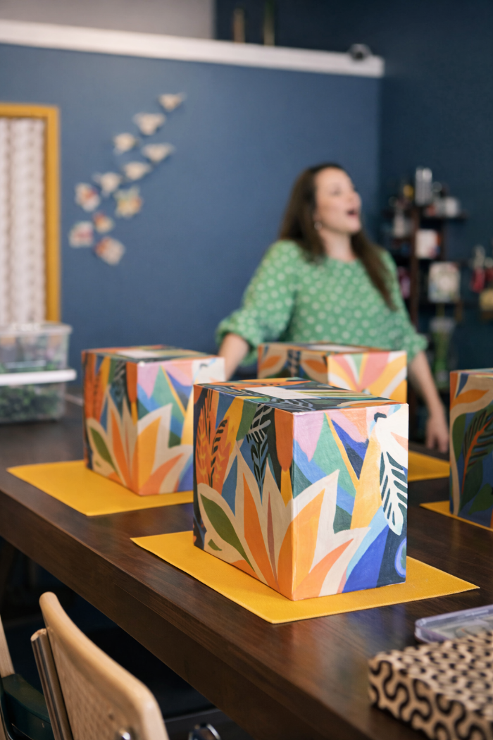 A row of craft kits is arranged for efficient assembly-line distribution during a large group event.
