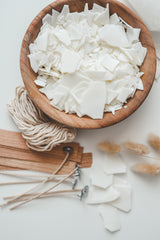 Blocks of natural candle-making wax stacked neatly on a surface, ready to be melted and used in a virtual candle-making class for teams. The wax is a key component in crafting personalized candles during the class.