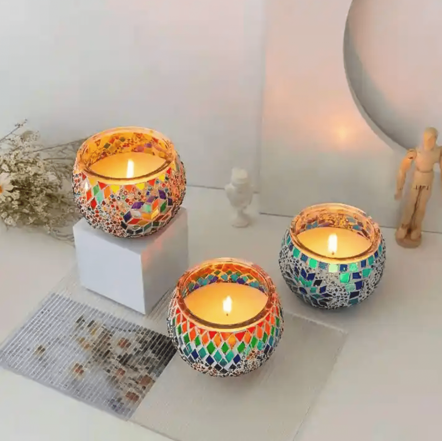 Colorful handmade Turkish mosaic candle holders with flaming candles, creating a warm and inviting ambiance.