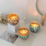 Colorful handmade Turkish mosaic candle holders with flaming candles, creating a warm and inviting ambiance.