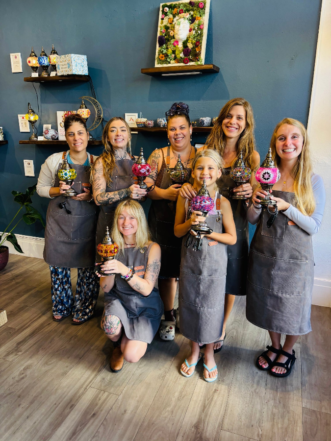 A family participating together in a hands-on craft workshop at the KraftStories San Francisco studio.