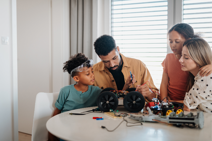 Family working together on electronic robot car
