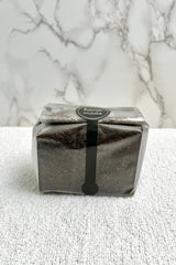 A black, rectangular package with a branded label on a marble background, Ultimate Terrarium Soil Mix