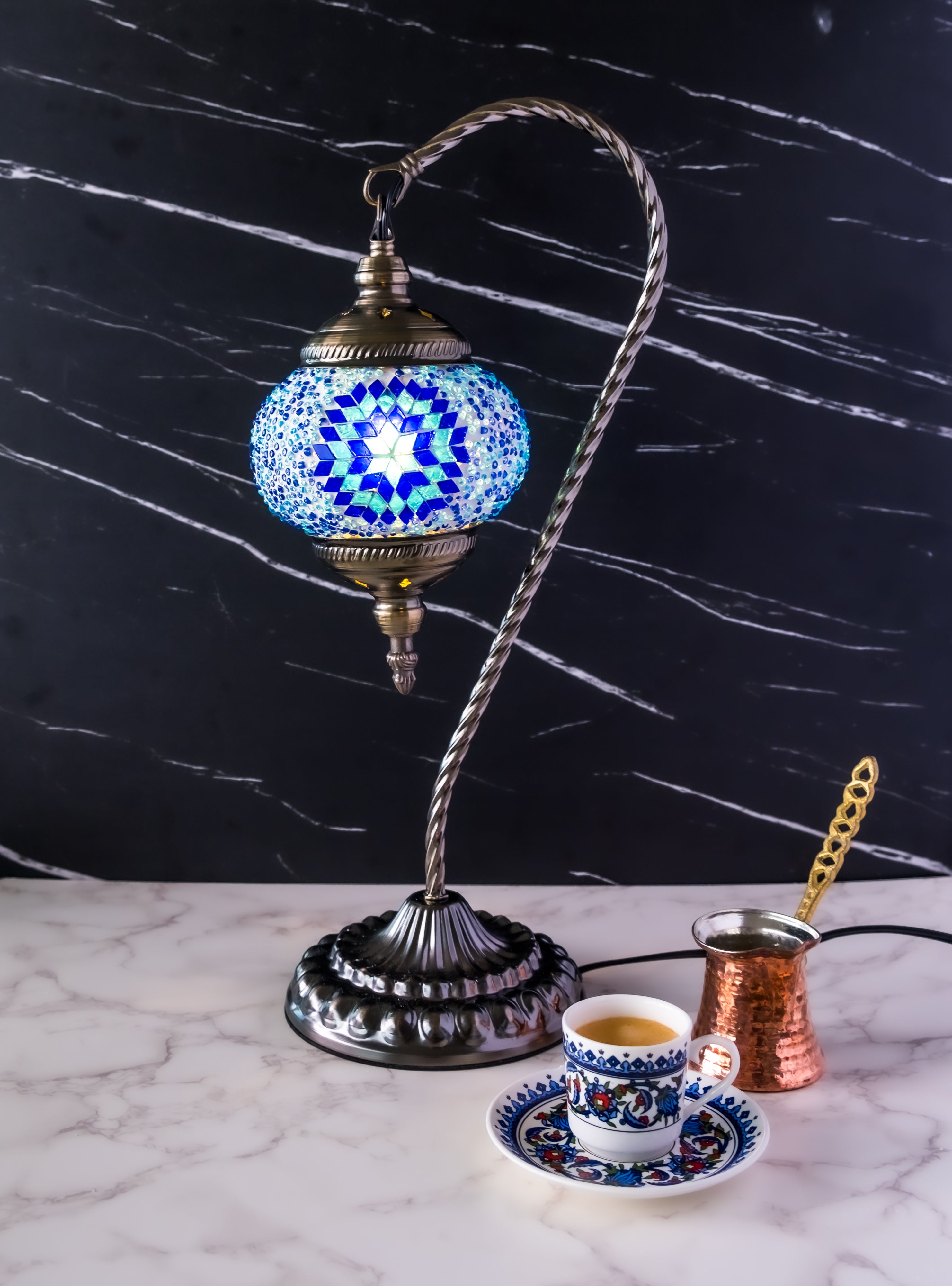 Colorful Turkish mosaic lamp with intricate blue and white patterns, complemented by a traditional metal base.