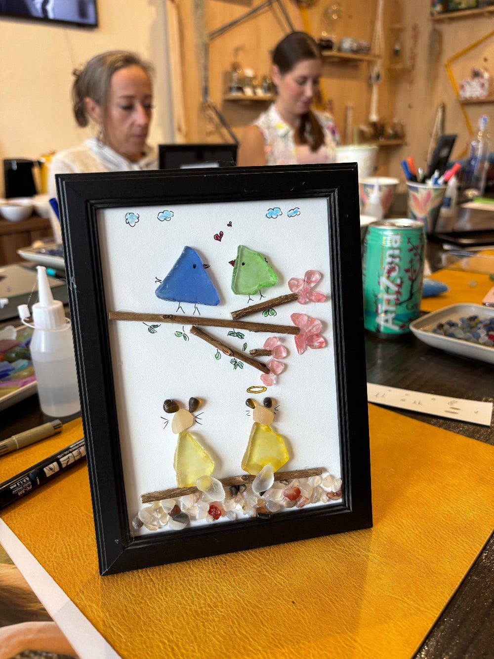 frame with sea glass art, showing birds and cats, make at KraftStories Hawaii, downton Honolulu