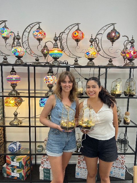 Guests proudly display their finished Turkish mosaic lamps at a KraftStories workshop in San Francisco.