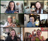 A vibrant group video call featuring six enthusiastic individuals, each proudly displaying their beautifully crafted glass terrariums and beaming with joy. Every participant is comfortably situated in their unique home or personal space, showcasing the warm and inviting ambiance of our craft workshops and kits.